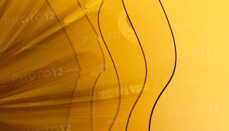 Abstract 3D render showcasing a vibrant crystal like structure with a smooth, glossy texture. The design features overlapping translucent layers against yellow background, creating a modern and minimalist aesthetic