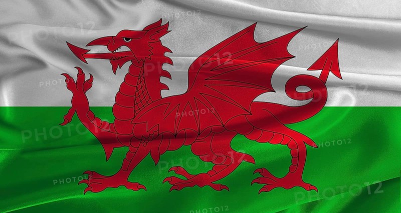 Flag of Wales with fabric textured background. Close up of National flag of Wales with realistic texture