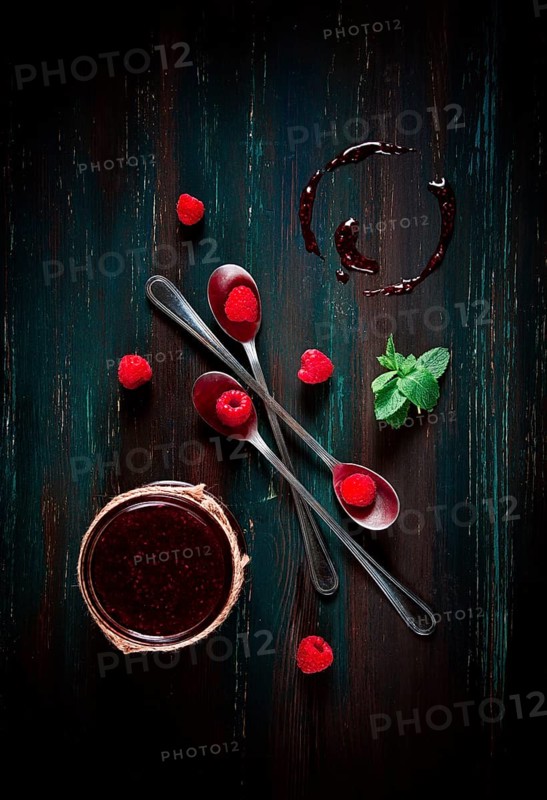 Raspberry jam, on a dark wooden background, top view, selective focus, food concept, no people