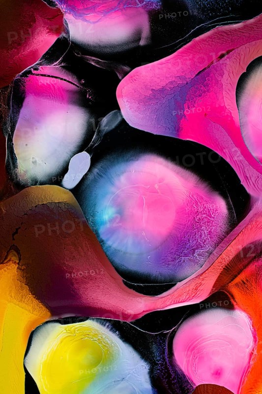 This vibrant abstract image features dynamic swirls of pink, yellow, and blue hues, creating a mesmerizing pattern of organic shapes and liquids textures against a dark backdrop