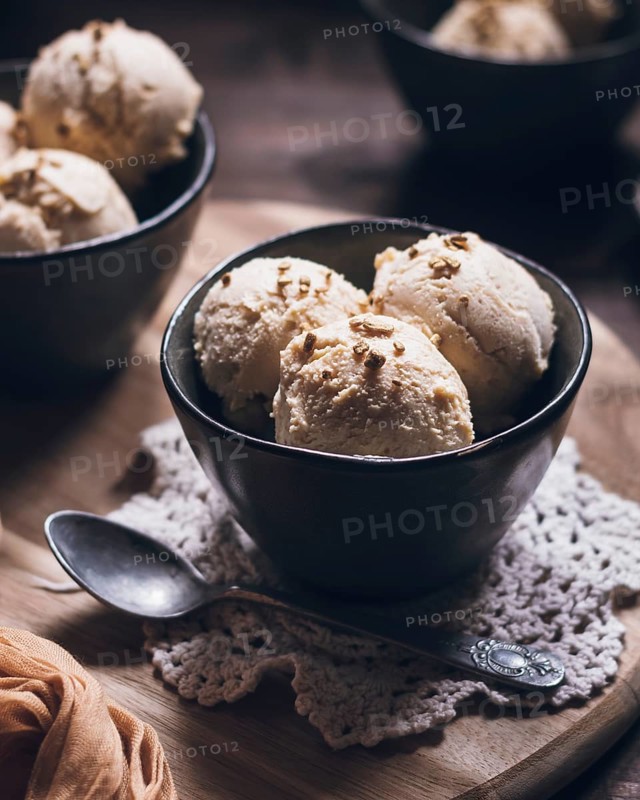A bowl of creamy peanut butter ice cream made with Greek yogurt and fresh cream. Topped with crunchy nuts, this dessert is perfect for a summer treat or indulgence