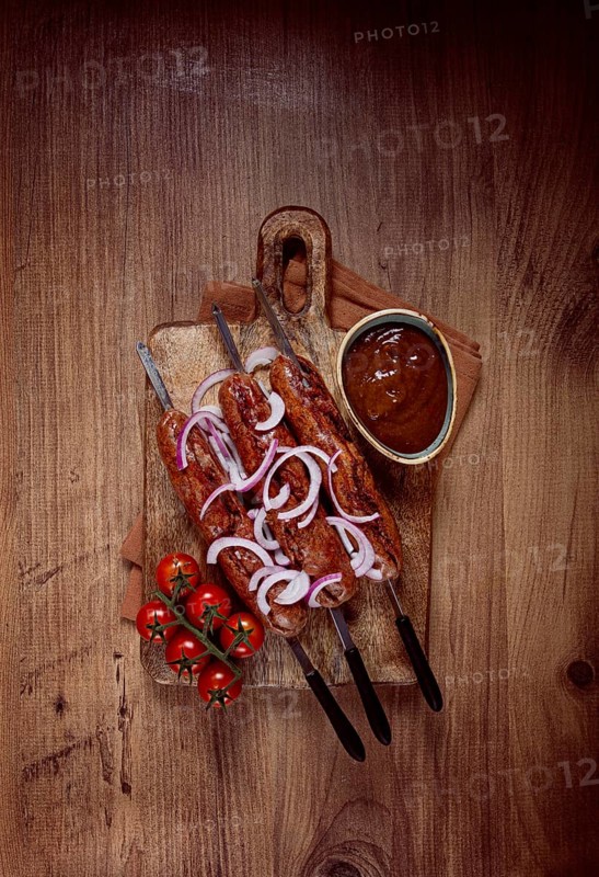 Fried sausages, in English with bacon, for grilling, on a cutting board, top view, no people