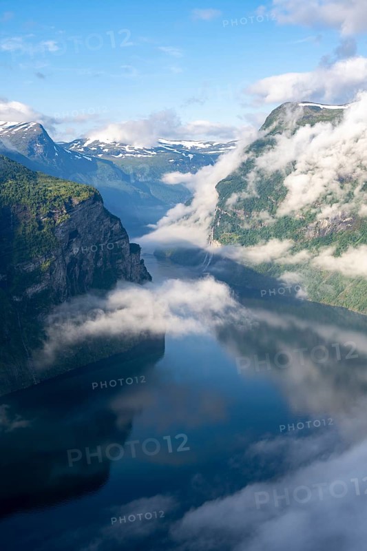 Atmospheric clouds over the fjord in the morning light, view of Geirangerfjord, at Ørnesvingen viewpoint, near Geiranger, Møre og Romsdal, Norway