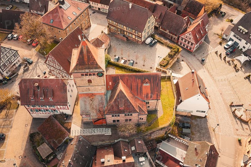 Historic old town area with a church in the center and surrounding half-timbered houses, Ötisheim, Enzkreis, Germany