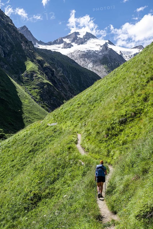 Hiker on hiking trail, view of Großer Schober and Rötspitze, Umbaltal, Hohe Tauern National Park, East Tyrol, Tyrol, Austria