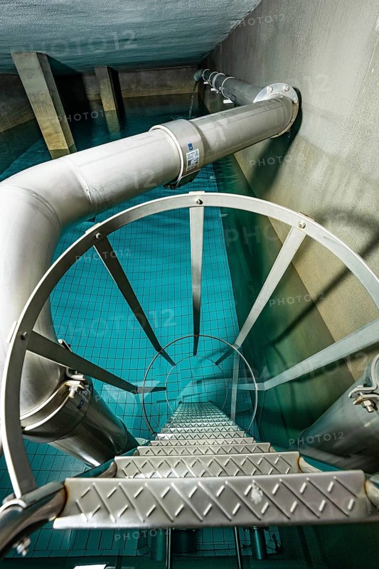 Metal tank with a spiral staircase and blue tiled floor, ENCW Netze Calw waterworks, Calw, Black Forest, Germany