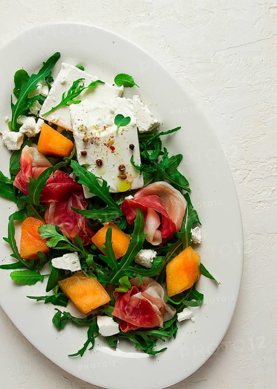 Salad, melon with prosciutto, arugula, and cheese, summer salad, vegetarian, homemade, no people
