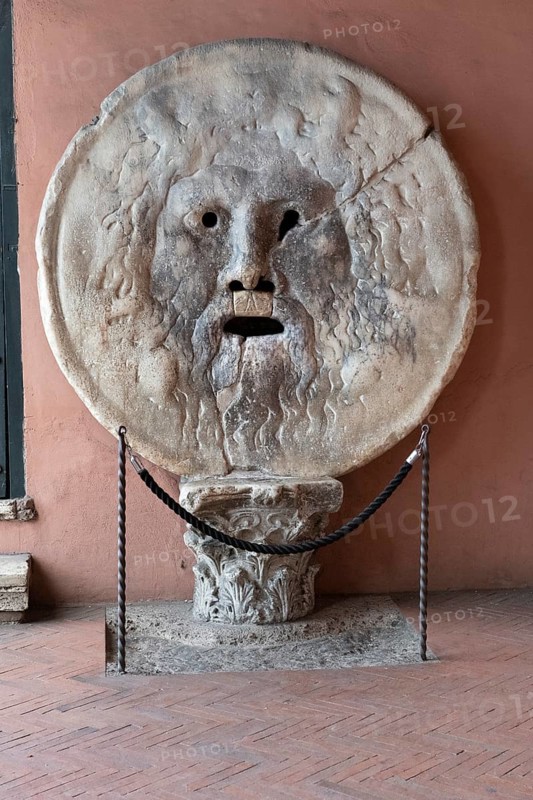 Approximately 2000 year old historical relief in the form of a marble disc Bocca della Verità Mouth of Truth in the portico of the Roman Catholic church Basilica minor Santa Maria in Cosmedin, Forum Boarium, Rome, Lazio, Rome, Italy