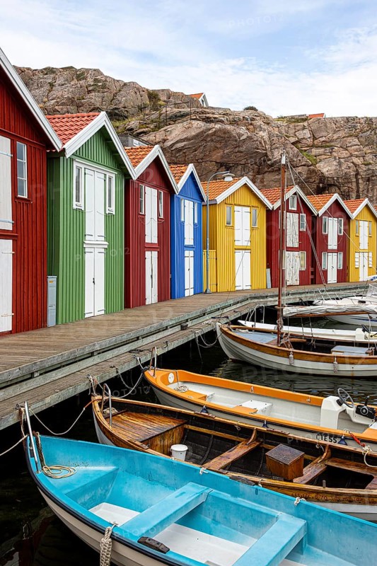 Small colourful houses by the sea. Typical houses in Sweden for the coastal landscape. Crab fishing and storage in a narrow harbour. Smögen, Smögenbryggan, Sweden