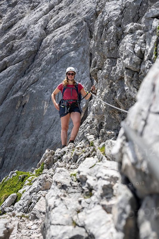 Mountaineer with helmet climbing in a secured via ferrata, Zugspitze via ferrata, ascent to the Zugspitze, Wetterstein range, Wetterstein range, Bavaria, Germany