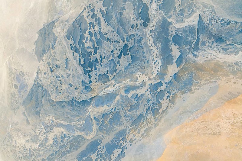 A breathtaking aerial photograph featuring a multicolour abstract landscape. This image captures an intricate mix of textures and colors that resemble a painterly art piece