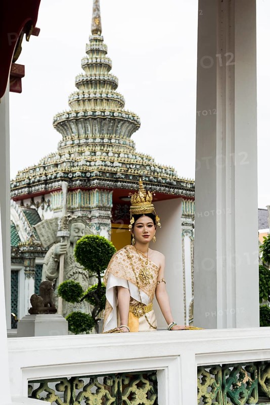 Thai traditionally and festively dressed young woman, Wat Pho, Bangkok, Thailand