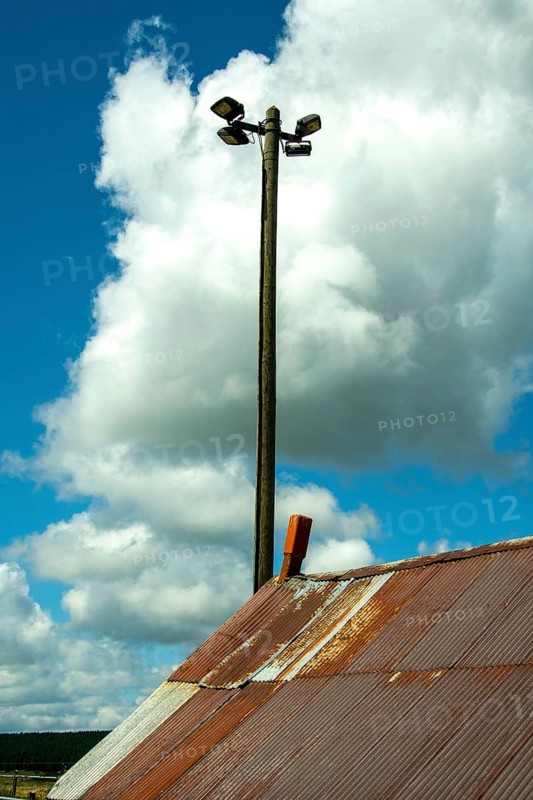 Lamppost and rusty tin roof. France