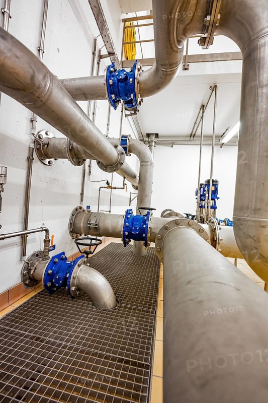 Complex pipe system with robust metal grid floor, ENCW Netze Calw waterworks, Calw, Black Forest, Germany