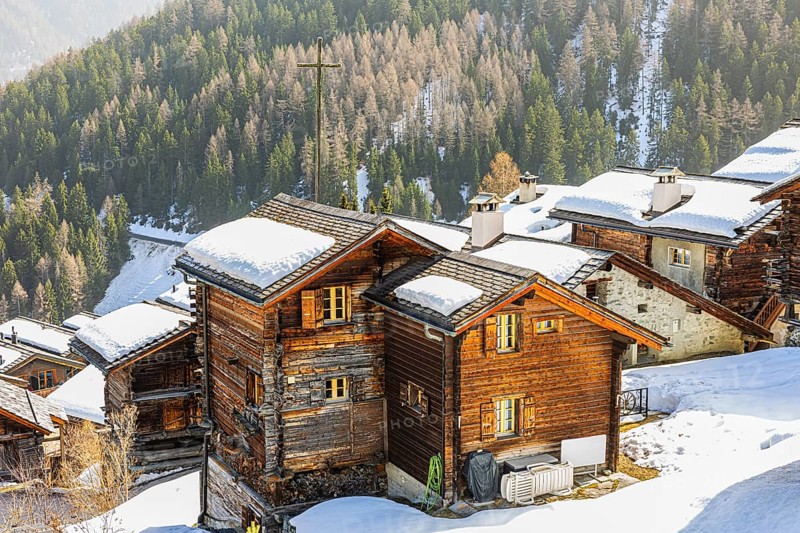 Snow-covered roofs of old farmhouses and Stadel warehouse, historic town center, Grimentz, Val d'Anniviers, Valais Alps, Canton of Valais, Switzerland