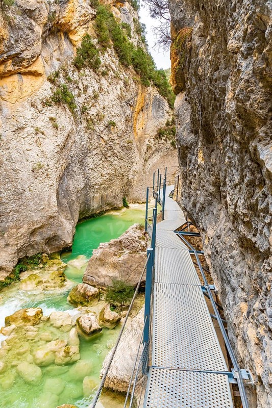 Walking along the metal walkways of the Vero River path in Alquezar. Pyrenees