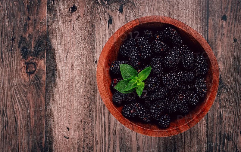 Blackberries, in a wooden bowl, top view, no people