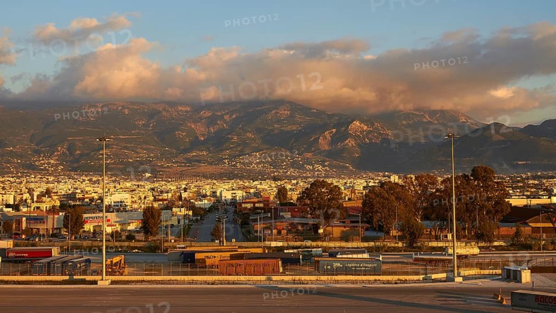 The city is picturesquely situated against a mountain backdrop in the warm evening light, New ferry port in the south of Patras, Ferries, Patras, Peloponnese, Greece