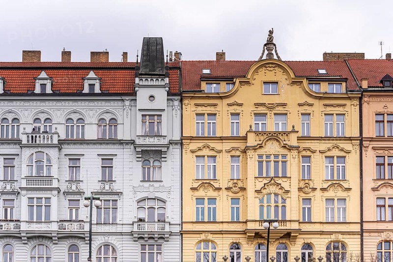A detailed view of ornate historical facades in Prague, featuring intricate designs, arched windows, and vibrant colors that exemplify classic European architectural style