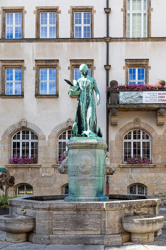 Dove girl on the Schlegelbrunnen fountain in front of the town hall, Döbeln, Saxony, Germany