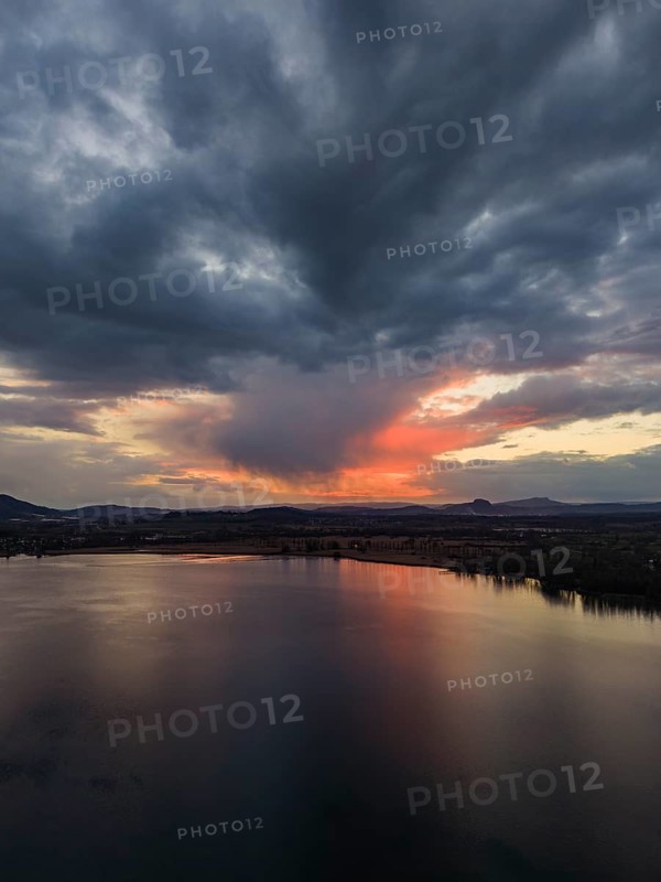 Aerial view of Lake Constance, Untersee near Radolfzell after sunset, on the horizon the Hegauberge Hohentwiel and Hohenstoffeln, district of Konstanz, Baden-Württemberg, Germany
