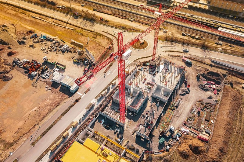 Complex construction site with large crane presence, located directly on roads and rails, new Mühlacker nursing home, Enzkreis, Germany