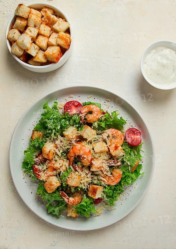 Caesar salad, with shrimp, on a white background, homemade, no people