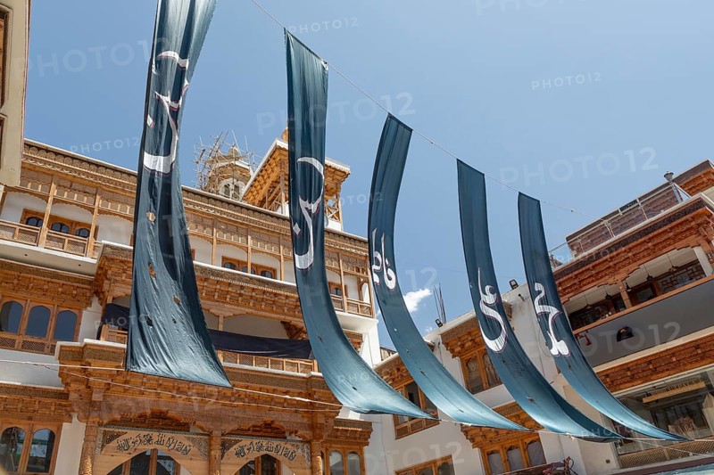 The Jamia Masjid Leh stands tall, adorned with striking turquoise banners that sway gracefully. This majestic mosque exemplifies the rich heritage and culture of Leh, India