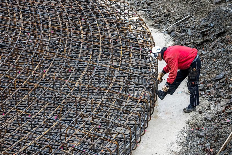 Assembly of reinforcing steel for the reinforced concrete foundation of a wind turbine, a mesh of rebar and reinforcing steel mesh, connecting the steel elements with binding wire, twisting with tongs, over 100 tons of reinforcing steel were used, the wind turbine will have a hub height of 160 meters, part of a new wind farm in Sauerland, near Balve, North Rhine-Westphalia, Germany