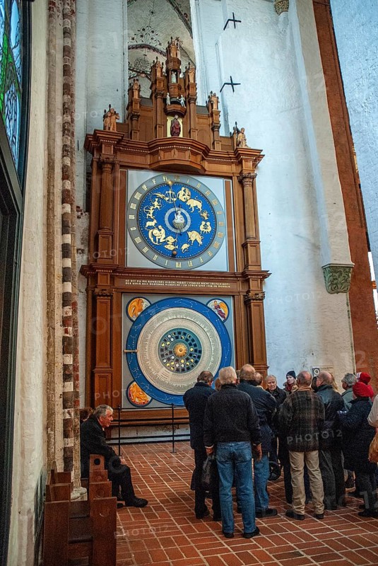 Group of tourists at the Astronomical Clock in St. Mary's Church in Lübeck, Schleswig-Holstein, Germany