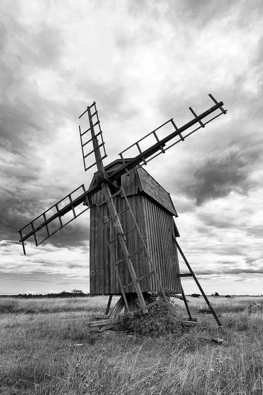 Historic windmill, Stora Alvaret, UNESCO World Heritage Site, agricultural landscape of South Öland, dramatic cloudy sky, monochrome, Gettlinge, Südoeland, Öland island, Kalmar län, Sweden
