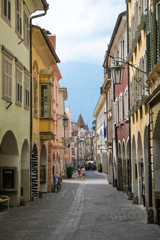 Merano, South Tyrol, Italy, A few passers-by stroll through the Laubengasse, the arcades are the heart of the old town centre