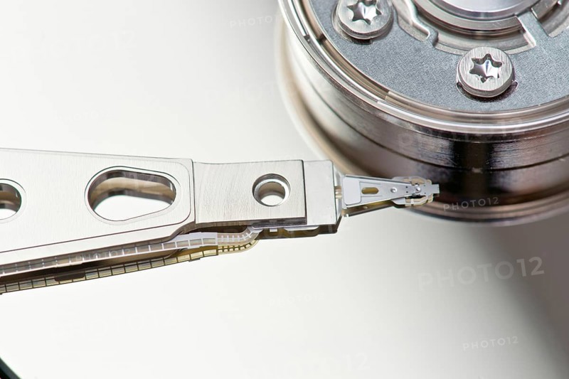 Detailed view of the arm mechanism of a hard drive including the read-write head and platter, highlighting the intricate engineering and precision components