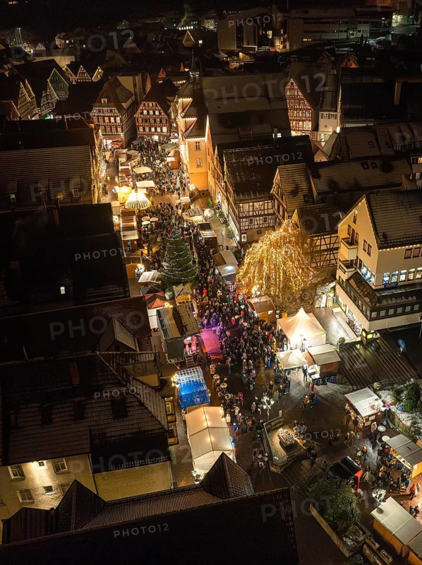 Crowd at a lively Christmas market in an illuminated city street, Christmas market Calw, Black Forest, Germany