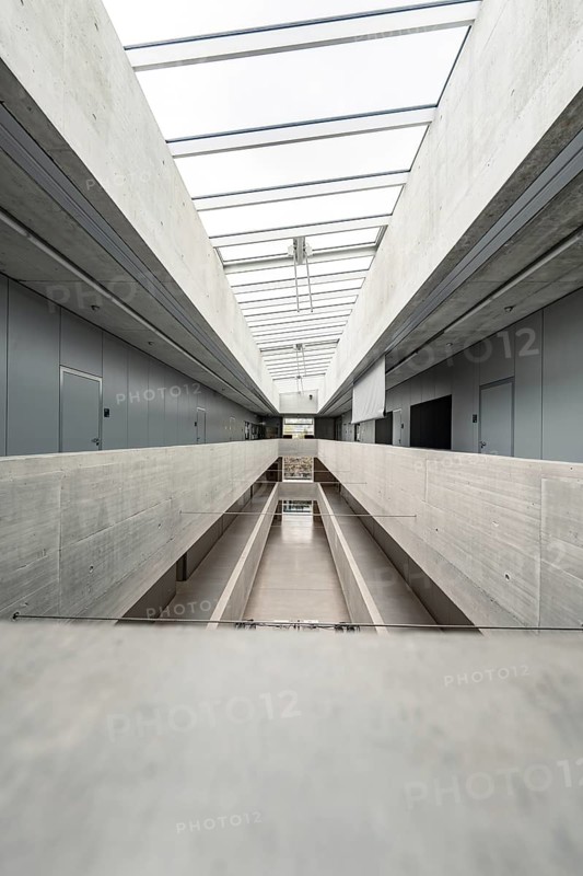 A long, bright corridor in a minimalist concrete style, flooded with daylight, University of Stuttgart, Germany