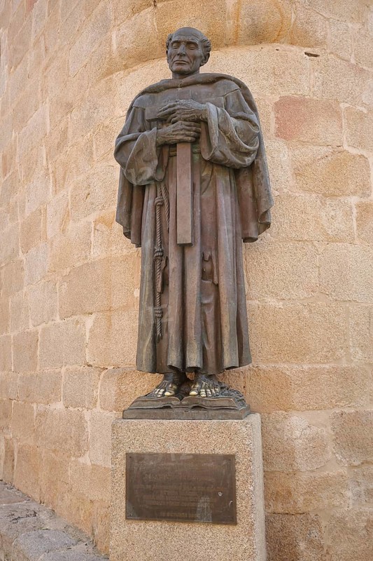 Monument to priest San Pedro de Alcantara 1499-1562, saint with cross, bronze sculpture, Plaza de Santa Maria, UNESCO old town, Caceres, Extremadura, Spain
