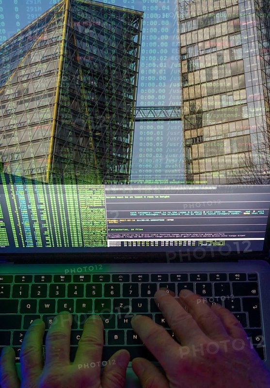 Symbolic image hacker, cyber attack on public buildings, administrations, institutions, town hall, authorities, digital blackmail, data theft, online criminal offences, cyber extortion, ransomware