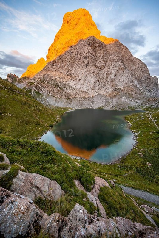 Alpenglow at Seekopf or Monte Capolago, reflection in Wolayersee, mountain landscape with green meadows and mountain lake at sunset, Carnic Alps, Carnic High Trail, Carinthia, Austria