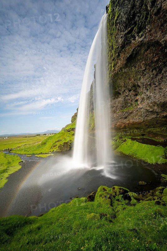 Seljalandsfoss waterfall with rainbow, long exposure, Seljalandsa river, South Iceland, Iceland
