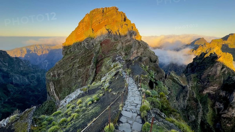 Sunrise at Pico do Arieiro, clouds of fog pass over mountain peaks, hiking trail PR1, Madeira, Portugal