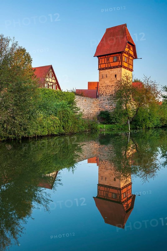 The Bäuerlinsturm on the town wall in the first morning light, reflection in the river Wörnitz, Romantic Road, Dinkelsbühl, Middle Franconia, Franconia, Bavaria, Germany