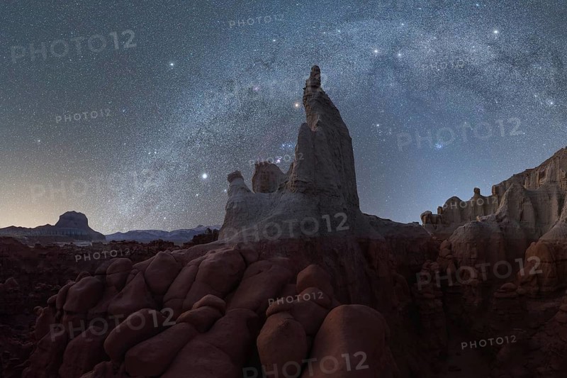 A mesmerizing night sky filled with stars above ancient rock formations in Utah, USA, providing a stunning landscape for astrophotography and exploration
