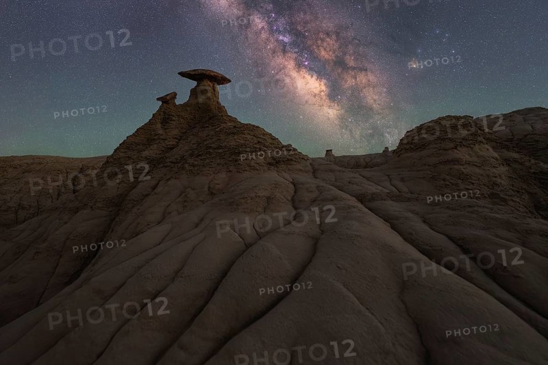 A mesmerizing view of the Milky Way shining brightly over the unique sandstone formations in Goblin Valley State Park, Utah, under a starry night sky