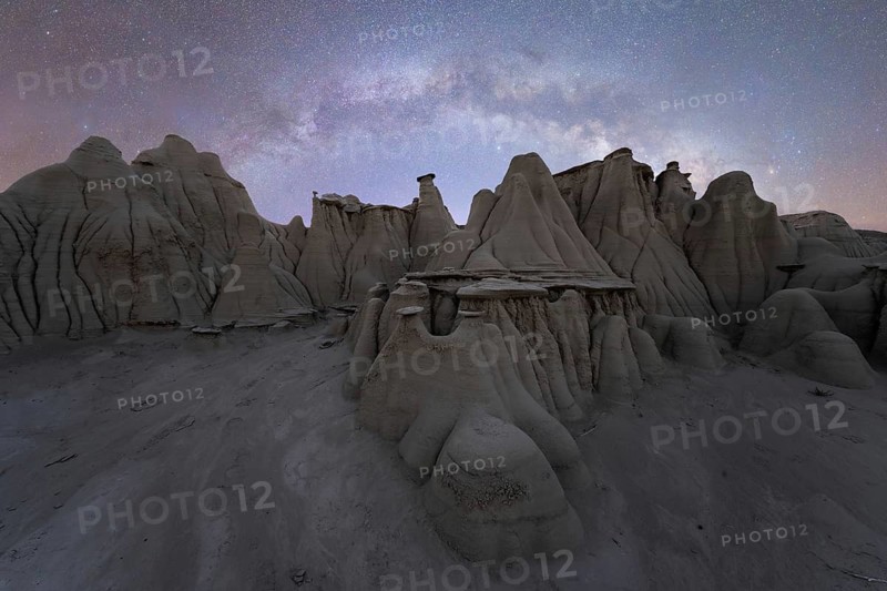 Captivating landscape of unique rock formations under a star-studded sky in Utah, USA, capturing the otherworldly beauty of nature at night