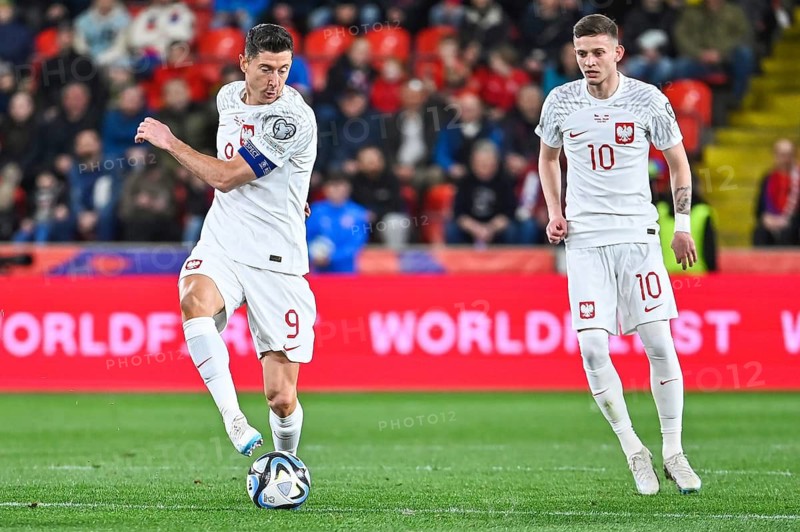 PRAGUE, CZECH REPUBLIC - MARCH 24, 2023: Qualifications for UEFA Euro 2024. Match Czech Republic - Poland 3:1. In action Robert Lewandowski (L) and Sebastian Szymanski (R).