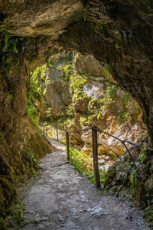 Scenic hiking path winding through the stunning tolmin gorge in slovenia, showcasing the natural beauty of the canyon