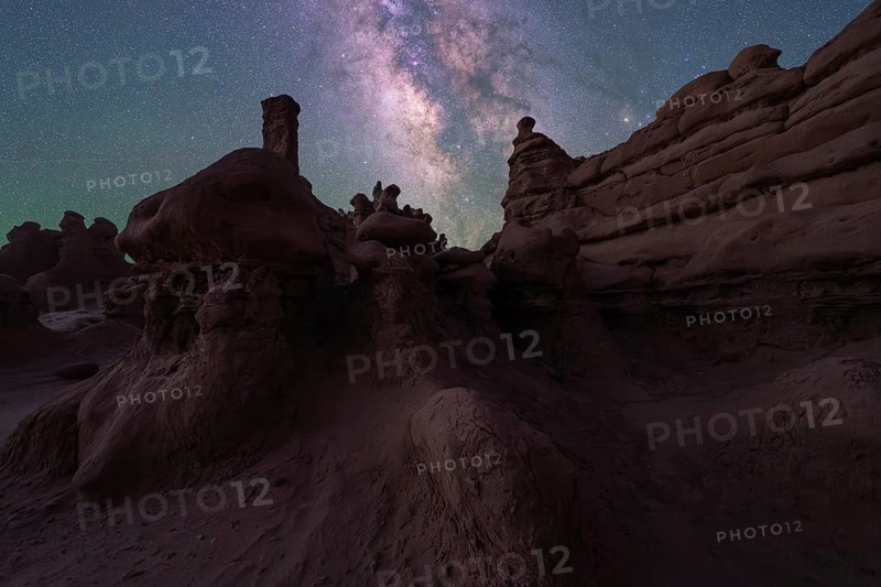 The night sky reveals the Milky Way over Goblin Valley's unique sandstone formations in Utah. The timeless landscape offers an awe-inspiring view of nature's beauty
