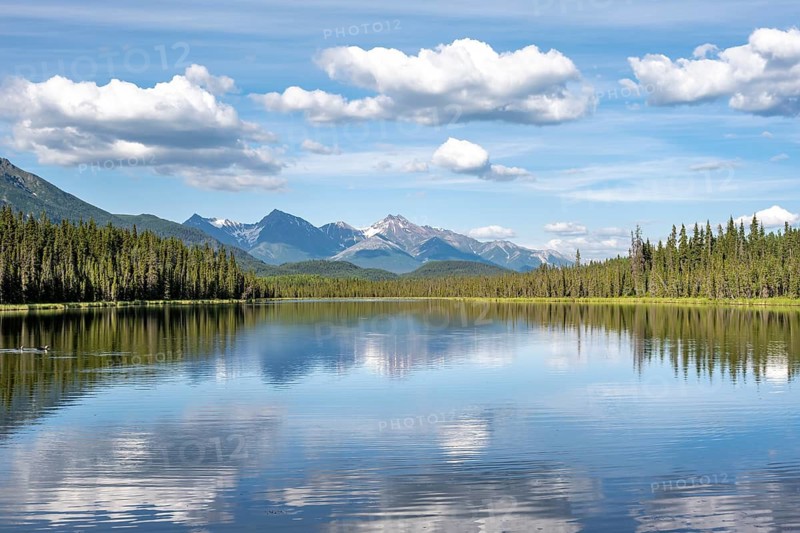 Mountains are reflected in idyllic Crystal Lake, McCarthy Highway, Wrangell St. Elias National Park, Alaska, USA