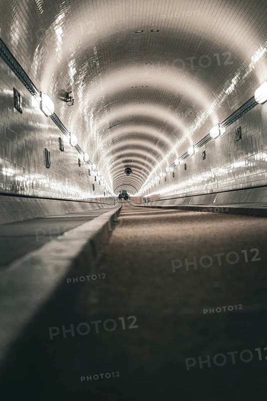 Long tiled tunnel with a perspective that emphasises the continuous lighting, old Elbe tunnel, Hamburg, Germany