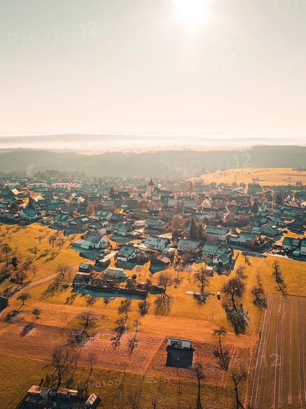 Village with church and fields under autumn sun, quiet and peaceful atmosphere, Neubulach, Black Forest, Germany